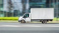 Ford Transit cargo box van truck in the city street. Side view of white light commercial vehicle in motion Royalty Free Stock Photo