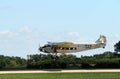 A Ford Tri-Motor Airplane lands at EAA AirVenture