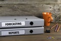 Forecasting and Reports - two folders on wooden office desk Royalty Free Stock Photo