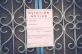 Foreclosed or eviction notice on a main door with blurred details of a house with vintage filter Royalty Free Stock Photo