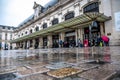 Forecourt of railroad station with little train traffic and people on a rainy day