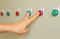 Forefinger and middle finger touch on switch button of machine. Royalty Free Stock Photo