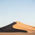 The foreground consists of flat textured sand typical of desert environments Royalty Free Stock Photo