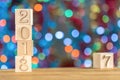 2018 in the foreground, displaces 2017. Christmas card. On bright bokeh background. Royalty Free Stock Photo