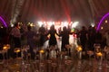 Foreground focus transparent vases on edge of glass table on wedding celebration. Red Disco lights background Royalty Free Stock Photo