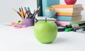 Foreground a green Apple on the background of school supplies .photo with copy space Royalty Free Stock Photo