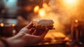 A close-up of a hand holding a freshly assembled s\'more, capturing the anticipation before the first bite.