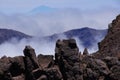 The foreground of lava rocks, volcanic mountain and summit of the Teide