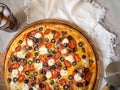 In the foreground is a photo of a pizza on a white background. High angle view. View from above. Close-up. No people. Color image Royalty Free Stock Photo