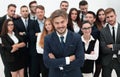 Smiling businessman standing on background of her business team. Royalty Free Stock Photo