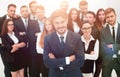 Smiling businessman standing on background of her business team. Royalty Free Stock Photo