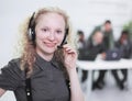 Foreground a young woman employee of a call center Royalty Free Stock Photo