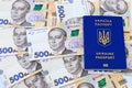 Foreign biometric passport with inscription in Ukrainian - Passport Ukraine, with new banknotes 500 hryvnia. Concept of money,