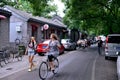 Foreign girl riding a bicycle in Beijing's hutongs