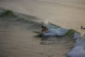 A foreign girl swimming in the sea on the waves, surfing