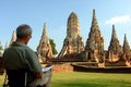 A foreign man are drawing Chaiwatthanaram temple at Ayutthaya Thailand in Ayutthaya