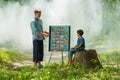 Foreign man teaching English language to Thai rural girl