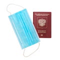 Foreign passport and protective medical mask on white background