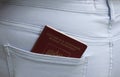 Foreign passport of the Russian Federation sticks out of the back pocket of jeans