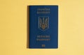 Foreign passport of Ukraine, isolated on the bright yellow sunny background