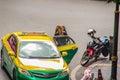 Foreign tourists backpacker is bargaining with the taxi driver. Taxi metered with the starting fee of 35 Baht for the first 3