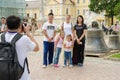 Foreign tourists are photographed with Russian visitors on the background of the bells in the Hol