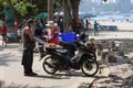 Foreigner buying a food from local on Beach Road in Pattaya, Thailand.