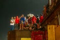 Foreigner tourists waiting and watching Varanasi Ganga Aarti at the holy Dasaswamedh Ghat, near Kashi Vishwanath Temple.