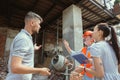 Foreman or achitect shows house, office or store design plans to a young couple