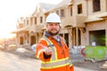 Foreman or architect in helmet giving keys from new house.