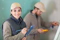 foreman builder and construction worker with blueprint in indoor apartment Royalty Free Stock Photo