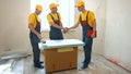 Foreman an builder shaking hands in indoor apartment. Royalty Free Stock Photo