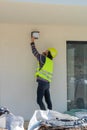 Foreman checking the installation of exterior lighting on a building under construction, site visit Royalty Free Stock Photo