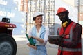 Foreman control loading Containers box from Cargo freight ship for import export. Royalty Free Stock Photo