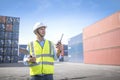 Foreman control loading containers box from cargo freight ship for import export, Foreman control industrial container cargo Royalty Free Stock Photo