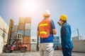 Foreman and dock worker staff pointing the finger and working at Container cargo harbor. Business Logistics import export shipping Royalty Free Stock Photo