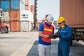 Foreman and dock worker staff working checking at Container cargo harbor holding clipboard. Business Logistics import export