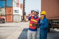 Foreman and dock worker staff working checking at Container cargo harbor holding clipboard. Business Logistics import export