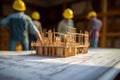 Foreman engineer and workers discussing at construction site, blueprint and house model on the table, teamwork, construction,