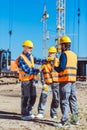 Foreman explaining builders work process by gesturing at the Royalty Free Stock Photo