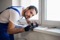 The fitter uses the level on the windowsill Royalty Free Stock Photo