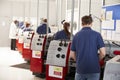 Foreman inspecting trainee engineers working in a factory