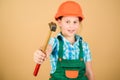 Foreman inspector. Little girl in helmet with hammer. Kid worker in hard hat. Labor day. 1 may. repair shop. hammer in Royalty Free Stock Photo