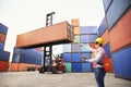 Foreman or Operator Ordering of moving containers with laptop computer. Foreman looking forward on Forklifts in the Industrial Royalty Free Stock Photo