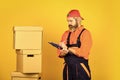 Foreman planning. unpacking moving boxes. new house at moving day. bearded man builder in boilersuit hold boxes. moving Royalty Free Stock Photo