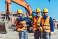 Foreman showing builders something at the construction site by pointing his