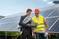 Foreman showing photovoltaic detail businessman at solar energy station