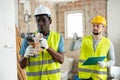 Foreman tells the builder where to drill holes with hammer drill Royalty Free Stock Photo