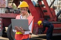 Foreman woman and worker man operate checking the forklift container cargo harbor holding laptop computer