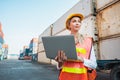 Foreman woman worker working checking at Container cargo harbor holding laptop computer to loading containers. Dock female staff Royalty Free Stock Photo